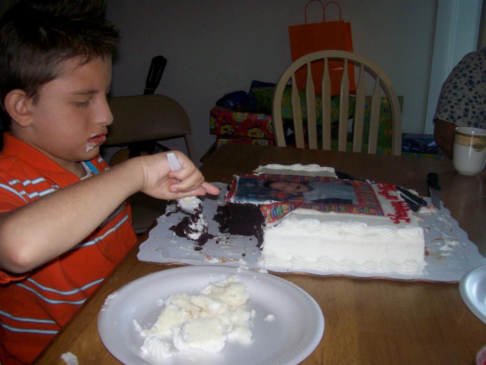 This is Quinten on his birthday- I'd given him white cake, trying to avoid a mess- but he decided he wanted chocolate! So he reached across the table, pulled the cake to him, and dug in! That's how Quinten was around food- you'd think it would be out of reach, but then he'd have it in his mouth as soon as you turned around. 