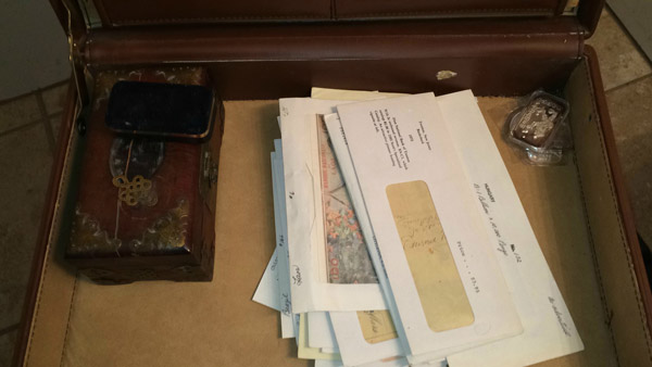 Inside: Old wooden box, jewelry box, envelopes with paper money of various countries and origins, 4 1 oz silver ingots.