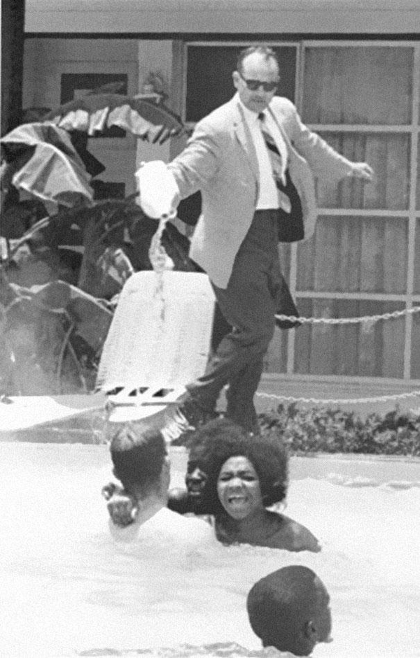 25.) A hotel owner pouring acid in a pool while a black family swam in it in 1964.