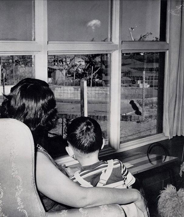 28.) A mother and her son look at the mushroom cloud following a nuclear test in Las Vegas in 1953.