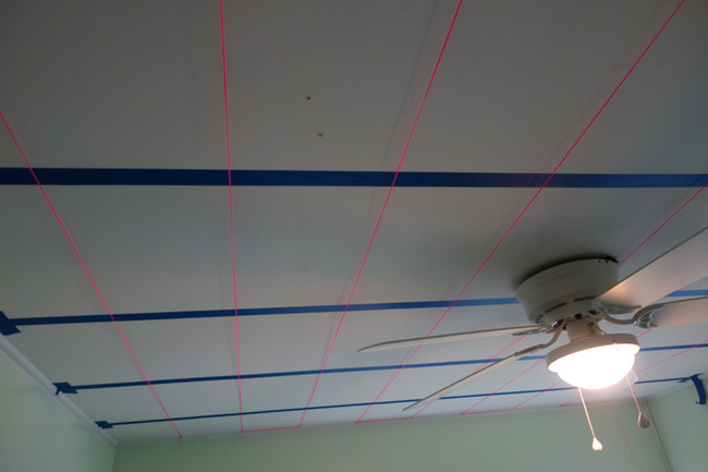 Then I used a staple gun and some kind of landscaping string to make a 1 ft x 1ft grid on the ceiling. I figured this way, the room is 12 x 10, which is 120 sqft, and there are 600 strands, that gives me 5 stars per sqft. I tried to drill the holes randomly, but the grid helped me maintain a pretty even layout.