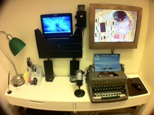 The laptop was mounted to the wall, a secondary monitor was added as well and then there was just enough space for his re-purposed typewriter.