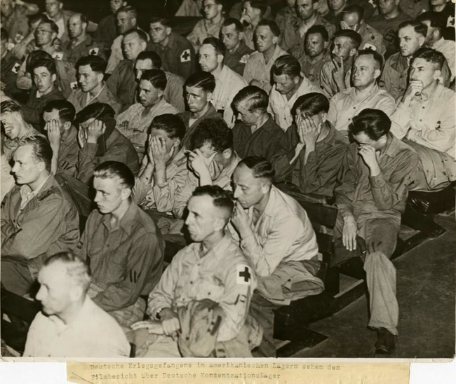 Nazi soldiers react as they are forced to watch footage from concentration camps.