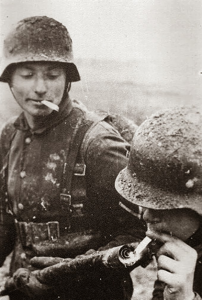 Using a flamethrower to light a cigarette. The German army employed flamethrowers on the Eastern Front during the war.