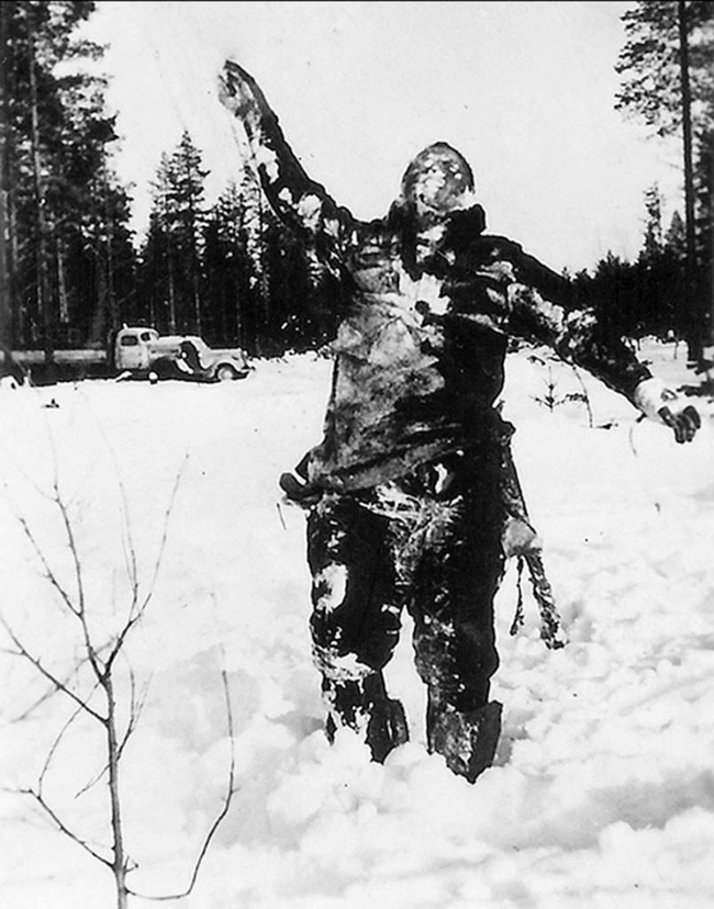 A frozen Soviet fighter propped up by Finnish soldiers to serve as psychological warfare against the invading Soviets.