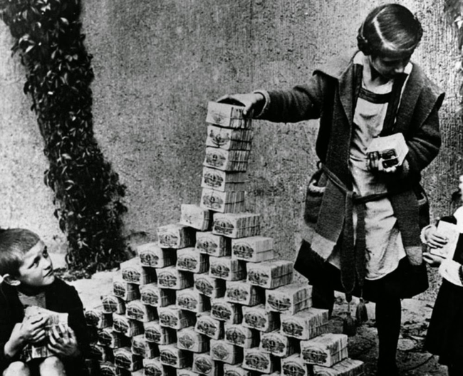 German children playing with stacks of money during the hyperinflation period of the Weimar Republic, 1922.