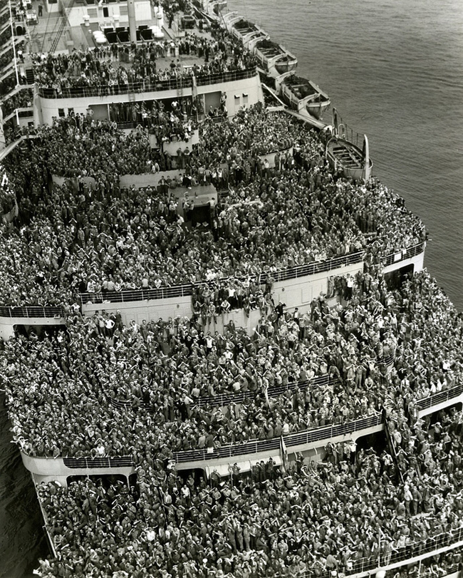 The crowded and happy ship bringing back troops to New York Harbor after V-Day in 1945.