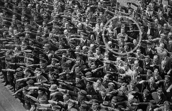 A man refusing to join the Nazi salute in 1936.