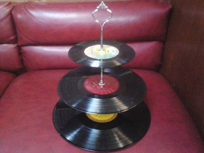 Different sized records stacked together make a one-of-a-kind dessert stand.