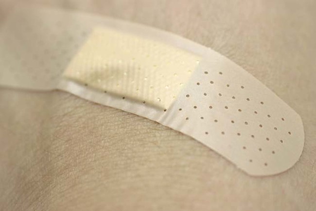 Dab a little bit of vodka on the sides of a Band-Aid to disintegrate the adhesive. Then pull it off without any pain.