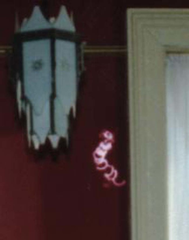 This bright squiggle wasn't seen on the negative, which means it was manually added after the film was already developed.