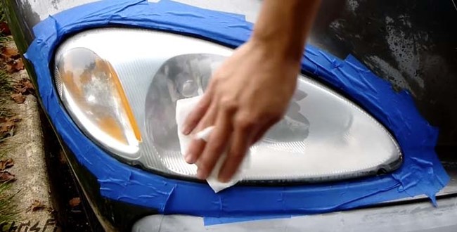 When you're finished with the sandpaper, use a lint-free paper towel to wipe down the headlight with rubbing alcohol.