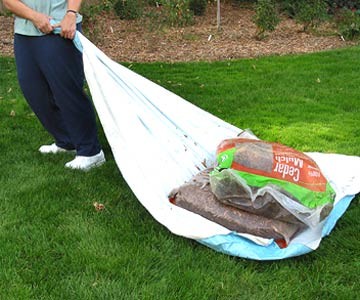 Don't break your back lugging heavy soil bags: use a tarp or table cloth to drag them.
