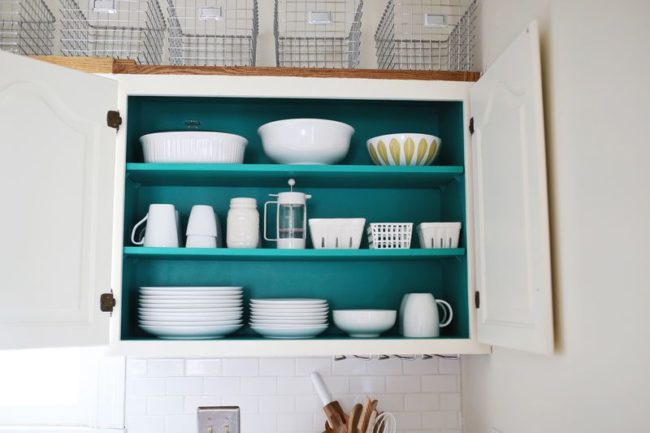 An all-white kitchen is nice -- but a pop of color inside the cabinets is arguably way more fun.