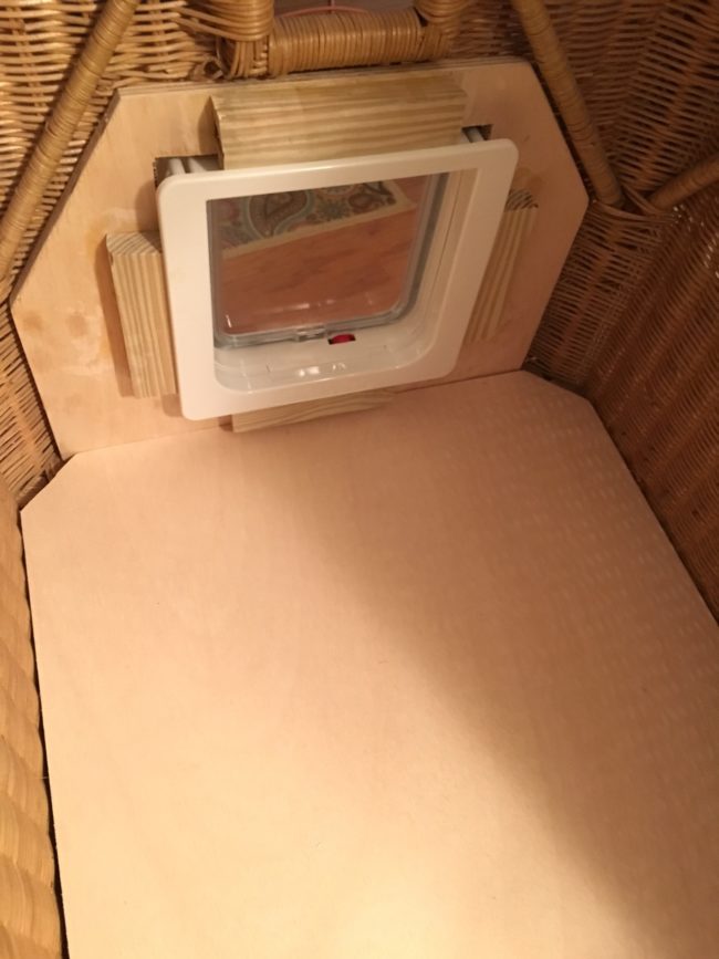 He placed the wood panel and door inside the chest and fitted them to the opening.