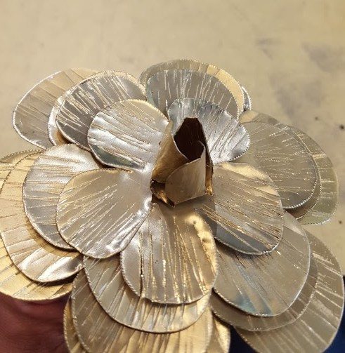 Then he gently folded the petals up with pliers.