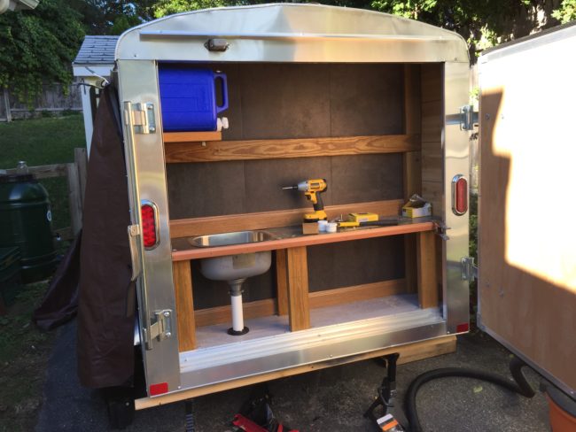 The builder installed some vinyl floor tiles to the galley and added a countertop equipped with a sink.