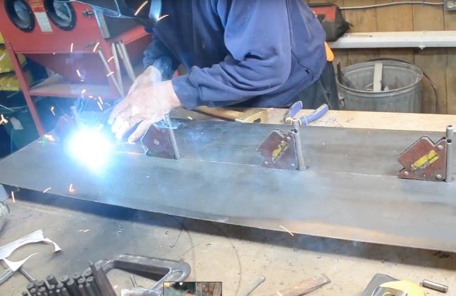 Then this crafty guy welded pipe supports into the back plate that would hold the lights up.This is where the water bottles would be attached and wired.