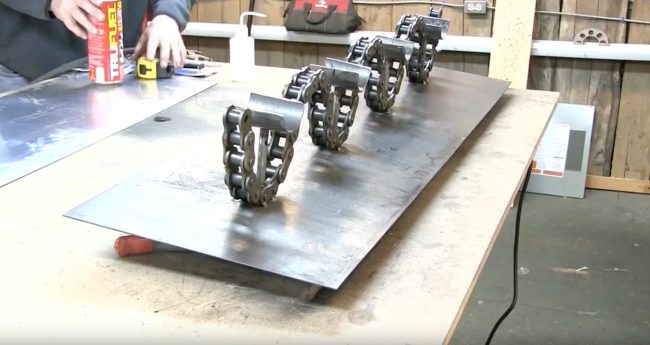 The next step was to weld the chain to the back plate and then weld tubing halves onto the pipes to support the bottles.Looking pretty cool already!