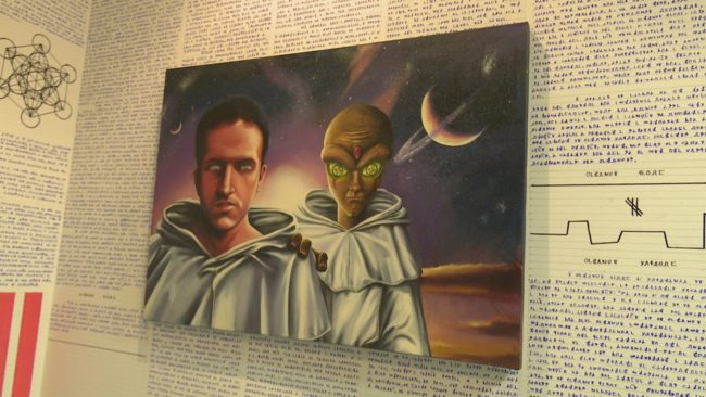 Hanging on one wall is a painting of Borges himself with an alien.