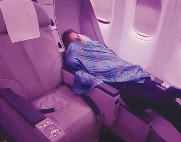 One passenger aboard the plane captured this photo of Hashmi sleeping in business class as his trainee was forced to carry through with most of the flight. 