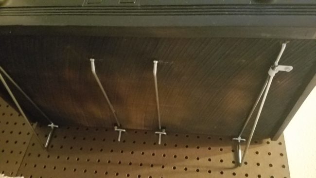With all the pegboards in place, they began installing hooks as they considered the best layout for the elevated climbing areas.