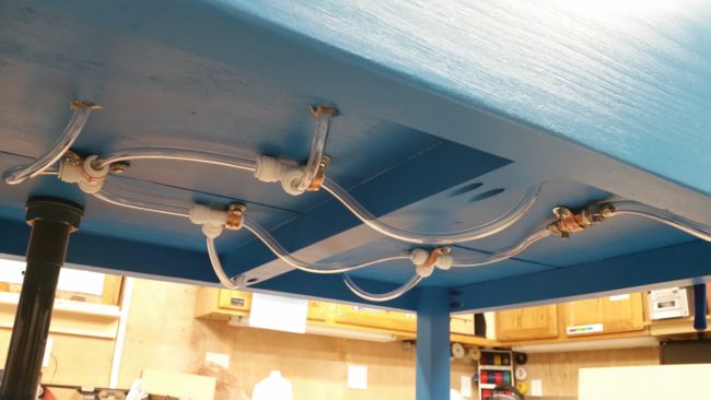 Copper clamps and screws kept the tubes secured to the underside.