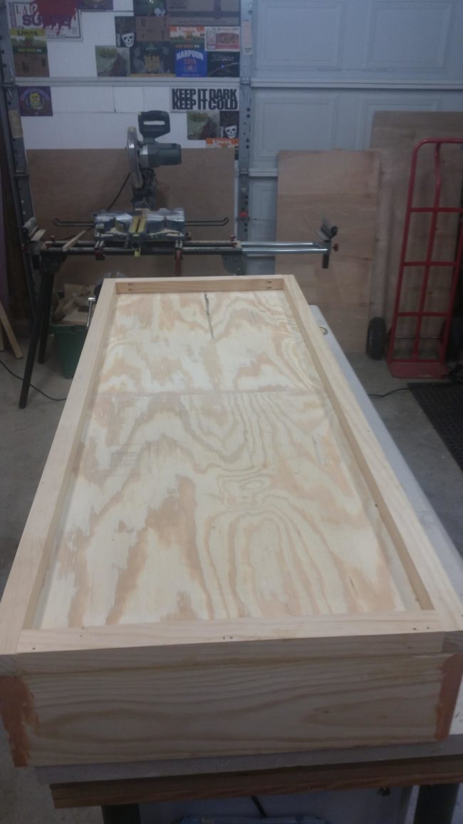 Then came time to glue and nail the plywood to the bottom and attach smaller pieces around the frame.