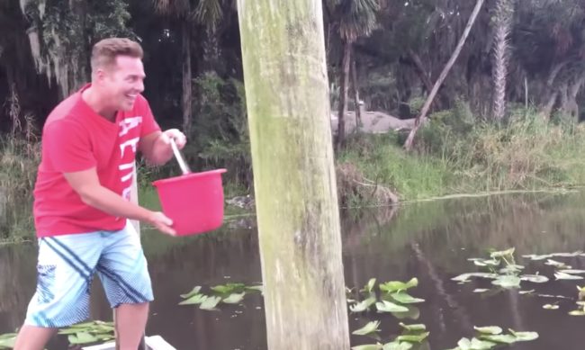 But once the man threw a bucket full of water into the lake, something beneath the surface totally lost its mind.