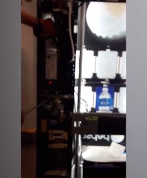 Using a rod and a gloved hand...