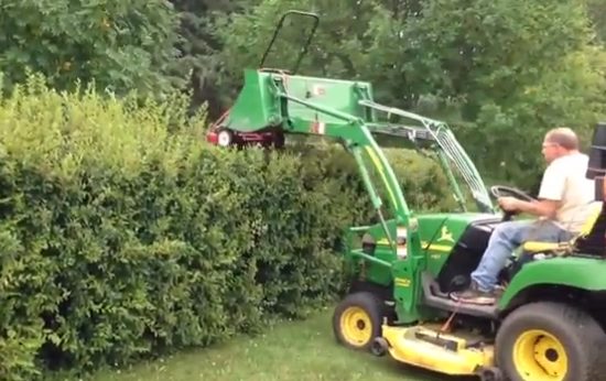 By attaching a lawn mower to a tractor...