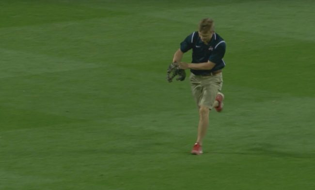 Eventually, an official steps in to drag her off the field, but she is not happy about it.