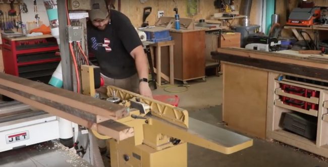 Since he's using reclaimed wood, the first step is to remove the nails and cut it to size.