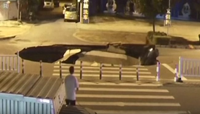 Because he'd been looking at his phone instead of the road, he drove straight in while another man watched without much concern...