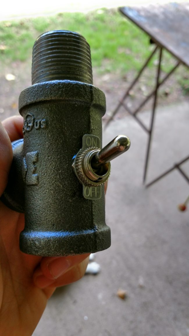 By drilling a hole into a T-fitting, our builder was able to create the perfect on/off switch for his lamp.