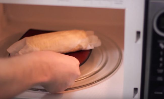 Remove the husks from a corn on the cob, wrap it in a damp paper towel, then nuke it and start nibbling!