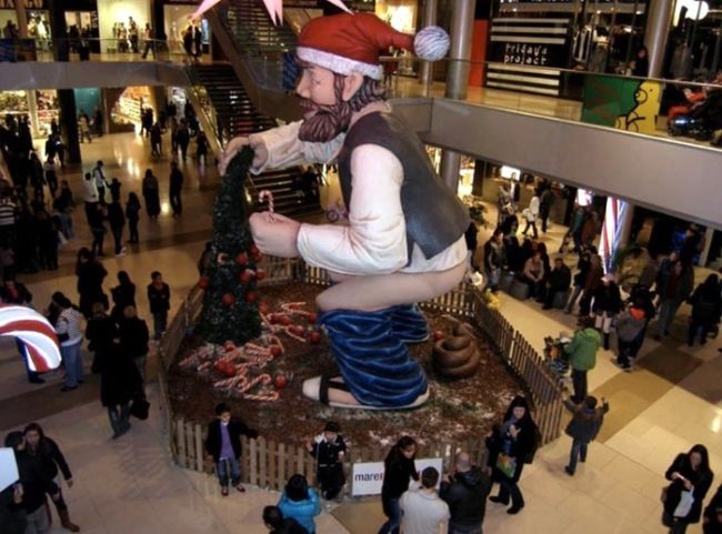 This display is called a Caganer, which is apparently a popular figure in nativity scenes in Catalonia. The more you know, I guess?