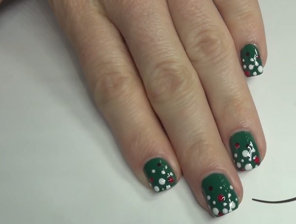 Create the abstract look of a Christmas tree and ornaments with this adorable manicure.