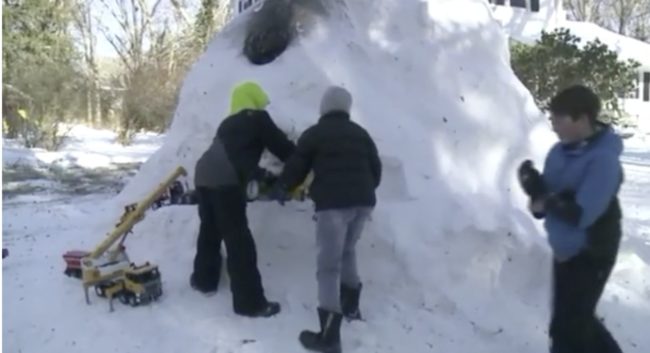 Then with the pile formed into the desired shape, the kids dig their way inside, helping to shape the walls and re-stack the snow on the outside for added support.