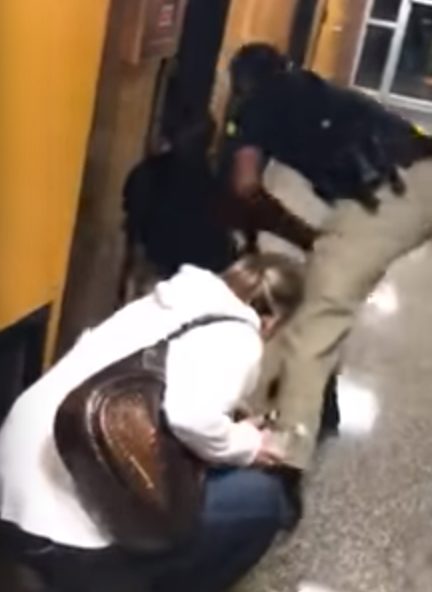 She complied and left, but moments later was forcibly put into handcuffs after appearing to have been pushed onto the floor.