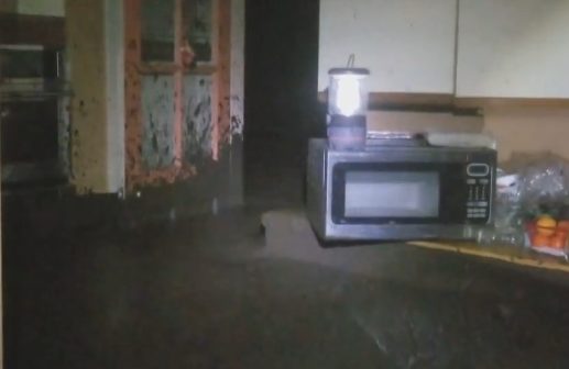 The family took shelter at the back of the house, standing in thigh-high mud for over an hour. At one point, it reached as high as the kitchen counters.