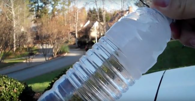 By tapping the supercooled bottled against the car, the water inside instantly froze and became slush. Amazing!