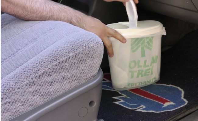 Re-purpose a plastic cereal container by making it into a car-friendly trash can.