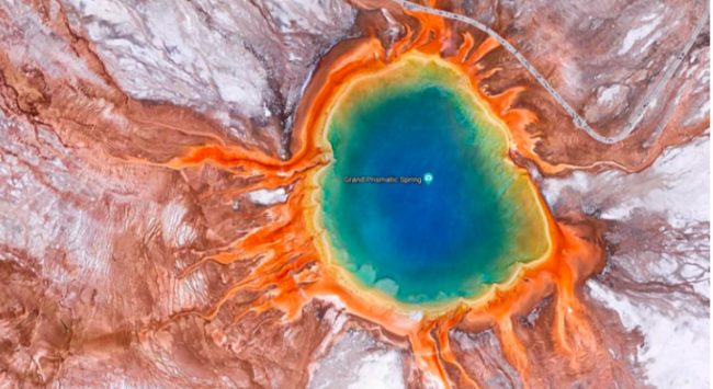 This pretty image is actually just the largest hot spring in the United States. The Grand Prismatic Spring is located in the Midway Geyser Basin in Yellowstone National Park.