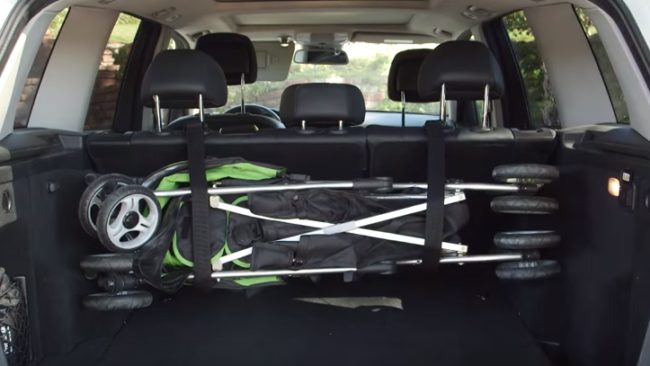 Loop a belt around both headrests and tighten them to keep your stroller safe and secure in the trunk of your car.